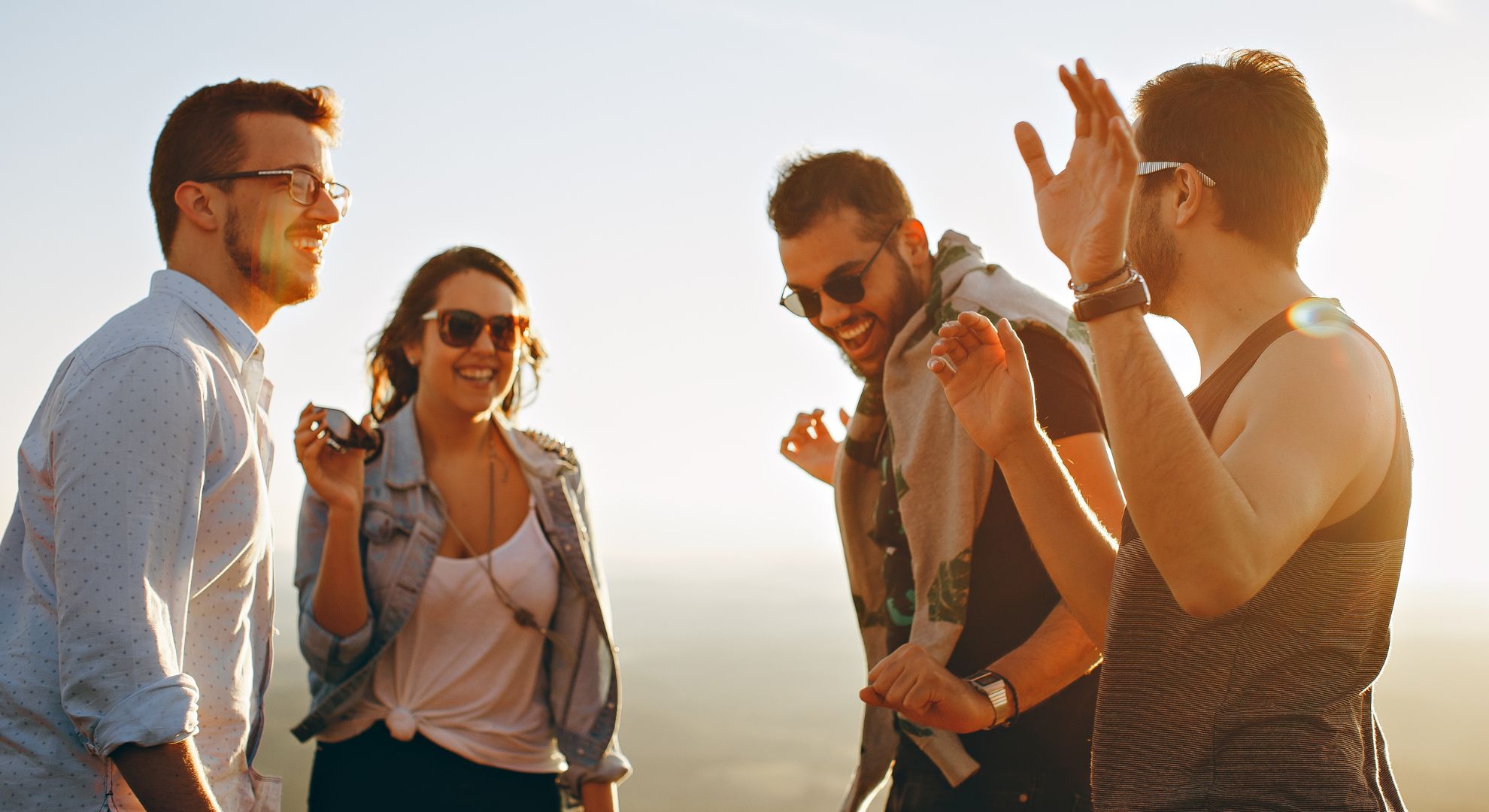 group stands in sunshine smiling